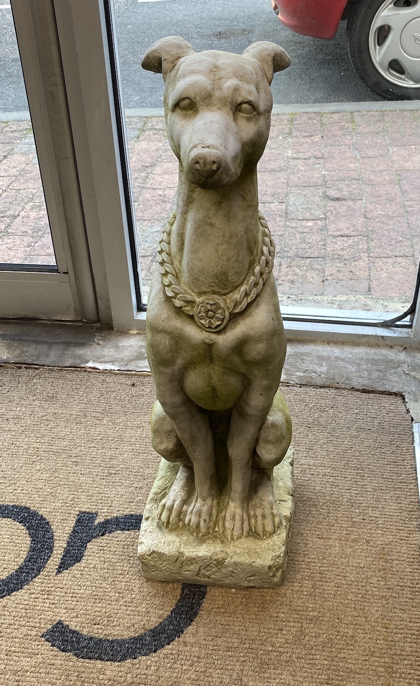 A pair of reconstituted stone seated greyhound garden ornaments, height 79cm